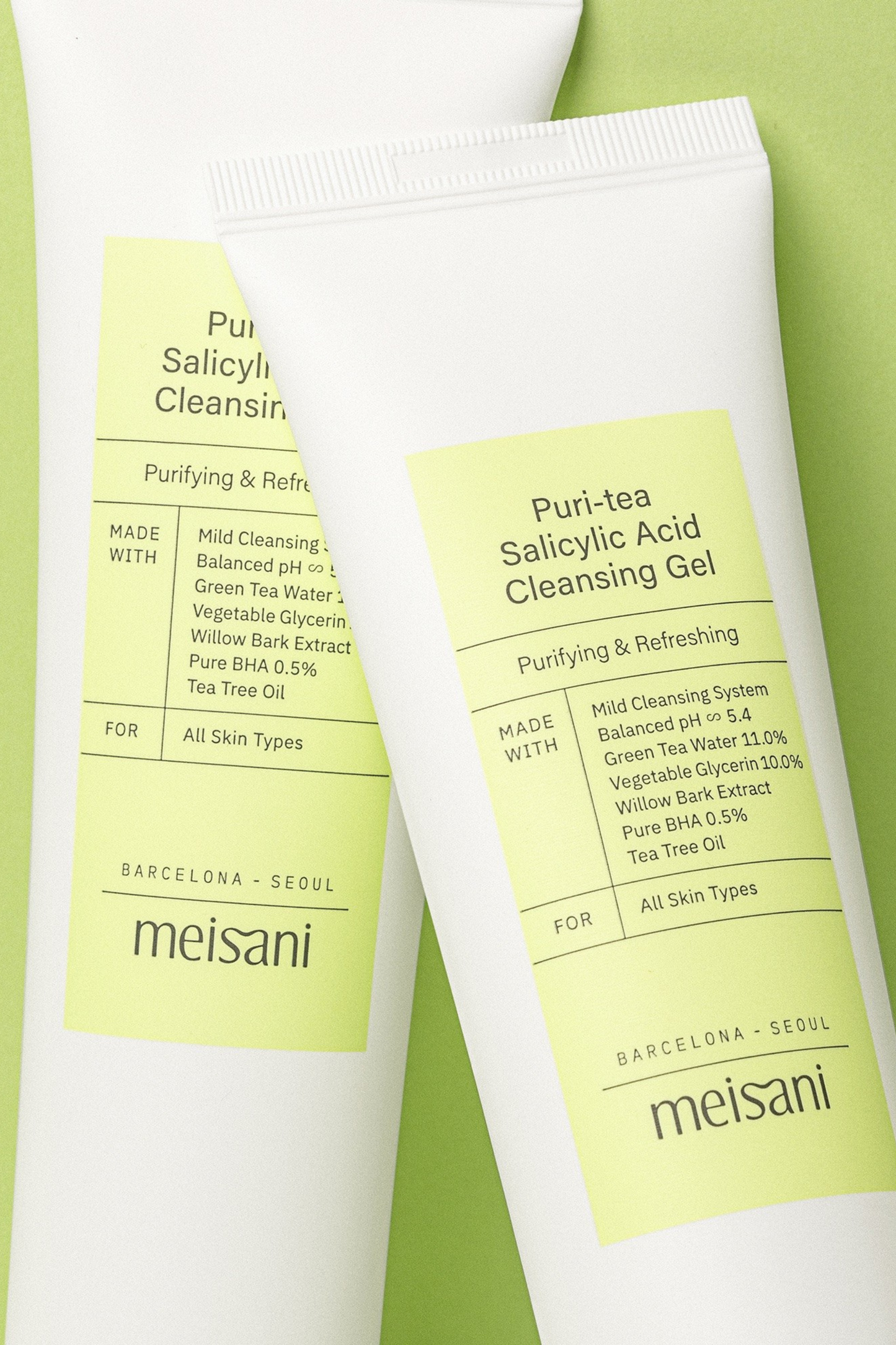 Two 150ml tube of Meisani's Puri-Tea Salicylic Acid Cleansing Gel side by side, with only the labels visible, against a light green background.