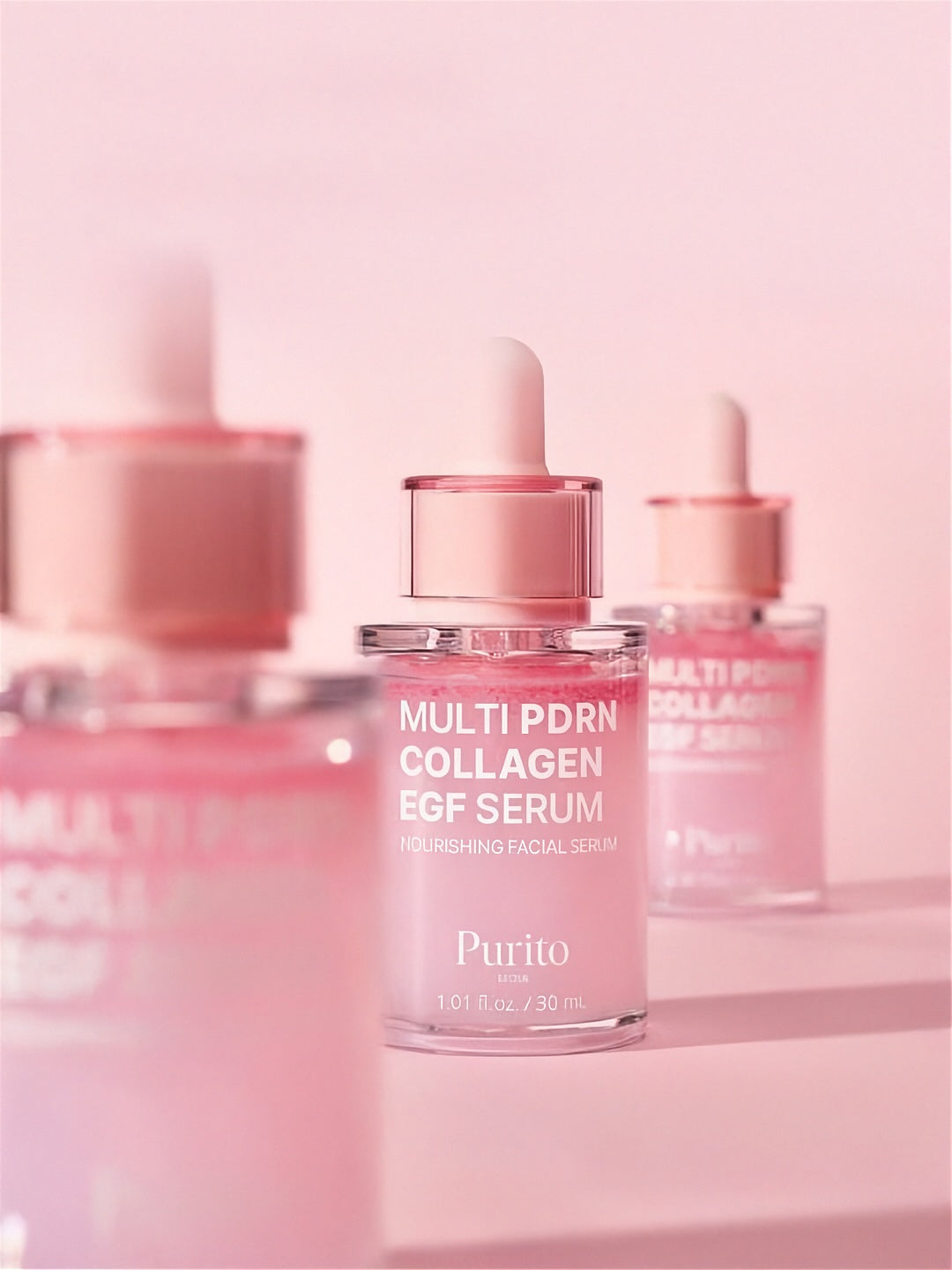 Three bottles of Purito Multi PDRN Collagen EGF Serum on a light pink background