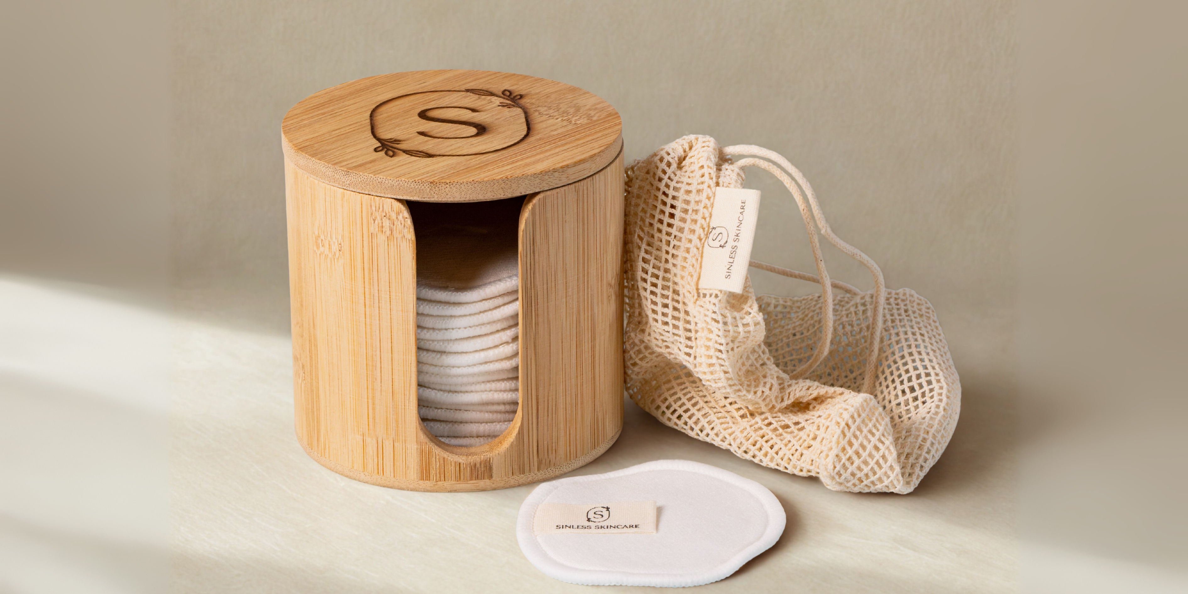Reusable cosmetic rounds bamboo box with mesh bag and pads visible. Available at Sinless Skincare.