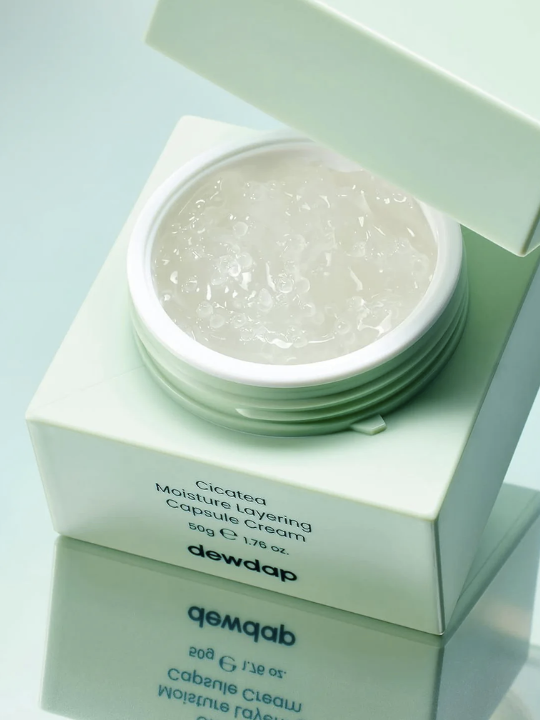 Dewdap Cicatea Moisture Layering Capsule Cream with an open lid, against a light green background. Available at Sinless Skincare Switzerland.