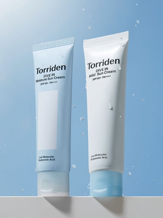 Two tubes of Torriden Dive In Sun Cream with water droplets on a light blue background