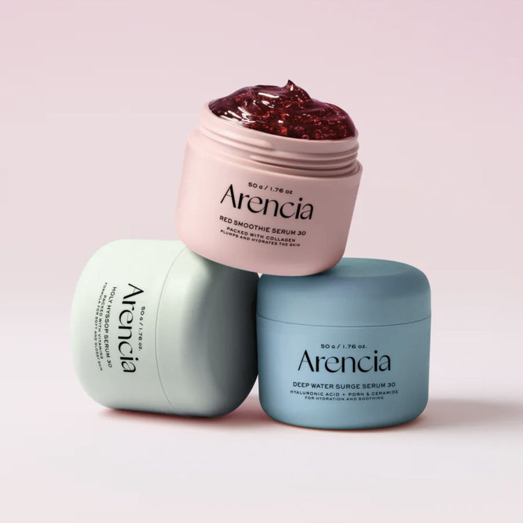 Three jars of Arencia jelly serums on a light pink background