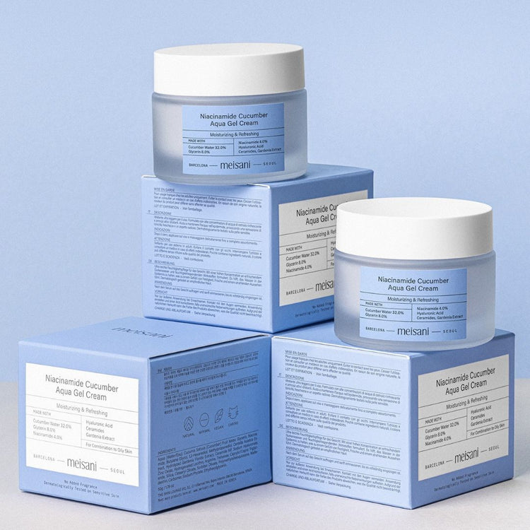 Two jars of Meisani Niacinamide Cucumber Aqua Gel Cream standing on retail boxes against a light blue background