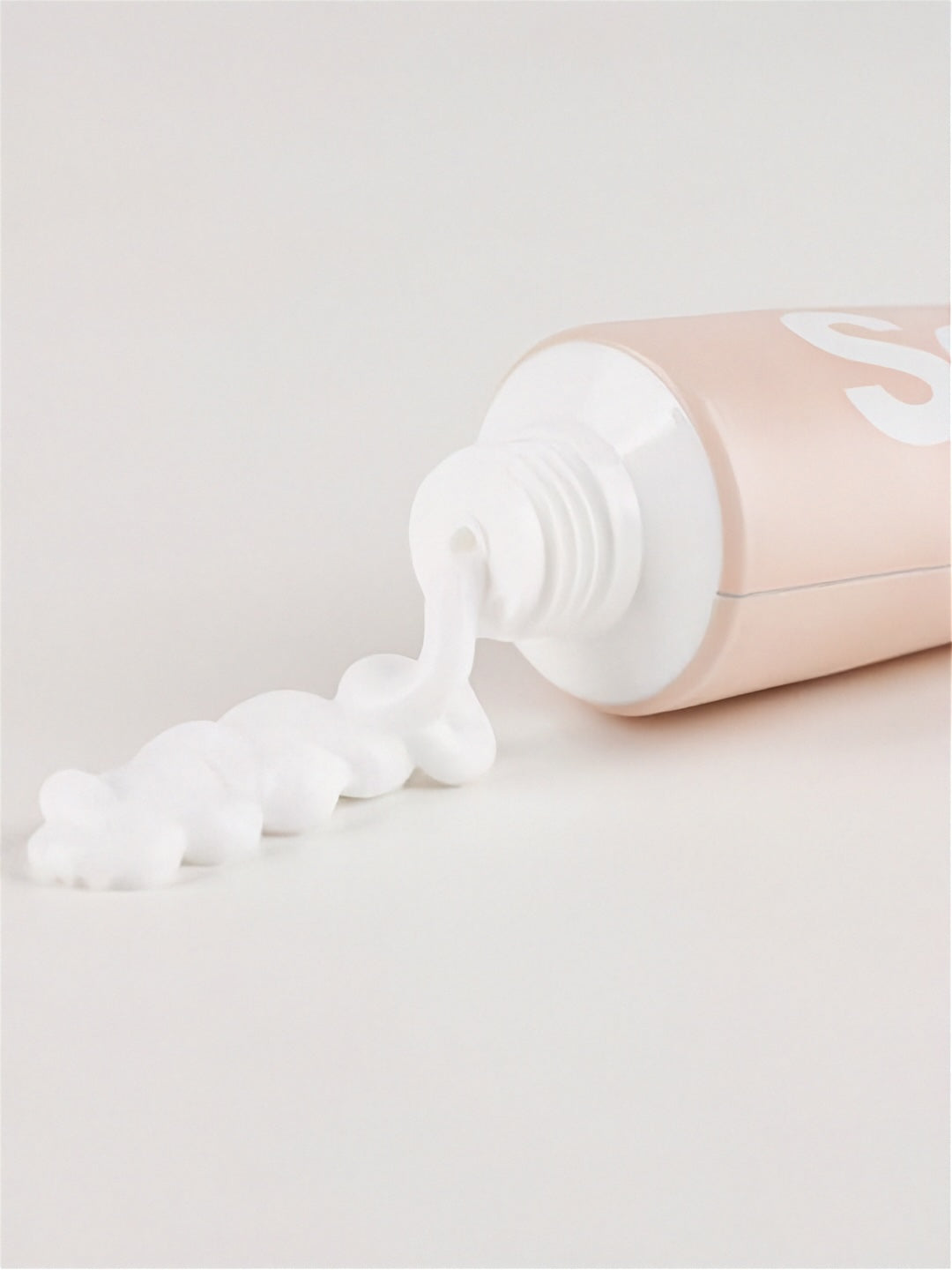 Top of Vegreen 730 Daily Moisture Cream tube with cream coming out on a light grey surface
