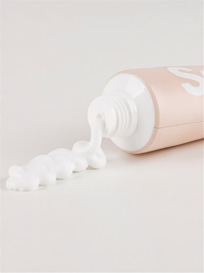 Top of Vegreen 730 Daily Moisture Cream tube with cream coming out on a light grey surface