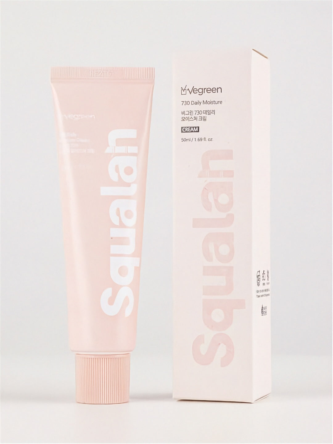 Tube of Vegreen 730 Daily Moisture Cream standing next to its retail box on a light grey background