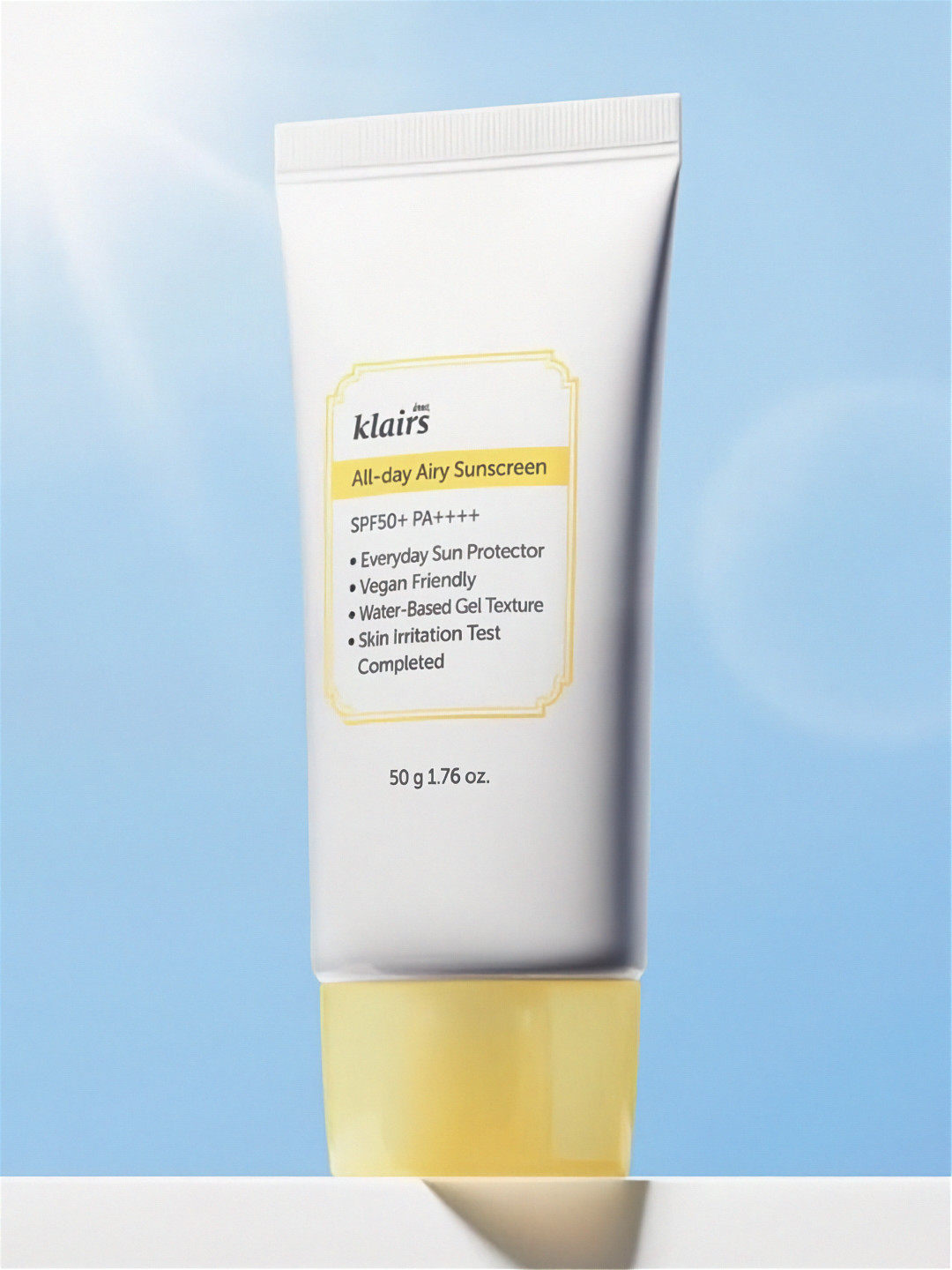 Klairs All Day Airy Sunscreen tube on a light blue sky background