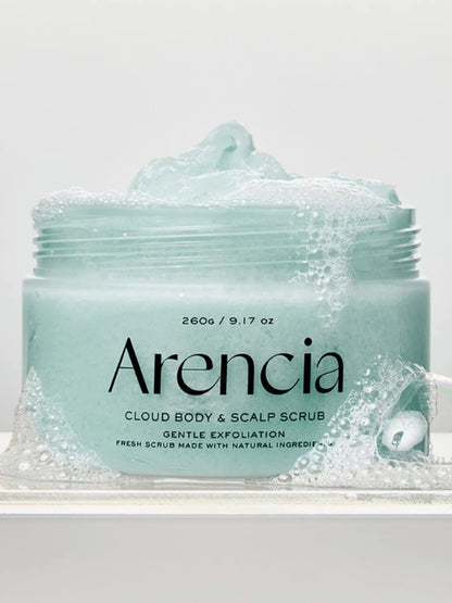 A jar of Arencia Cloud Body & Scalp Scrub French Mint & Lily  with light aqua scrub visible at the open top and around the base,, surrounded by bubbles, photographed on a clean white background.