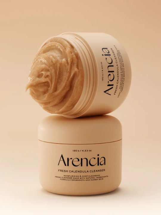 Two jars of Arencia Fresh Calendula Cleanser on a beige background