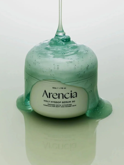 Jar of Arencia Holy Hyssop Serum 30 covered in green serum on a light green background. Available at Sinless Skincare.