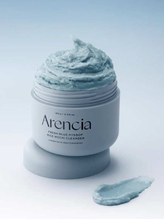 Jar of Arencia Blue Hyssop Rice Mochi Cleanser with blue texture on light blue background. Available at Sinless Skincare.