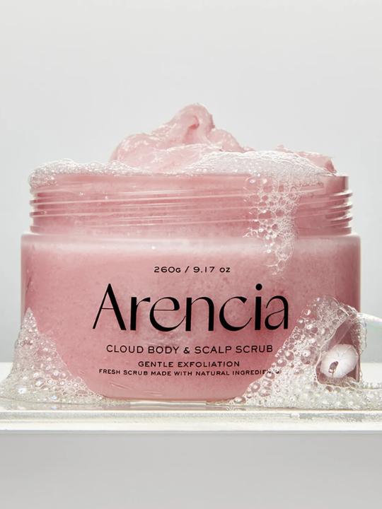 Open jar of Arencia Cloud Body & Scalp Scrub (Lavender & Pear) surrounded bubbles against a light grey background.