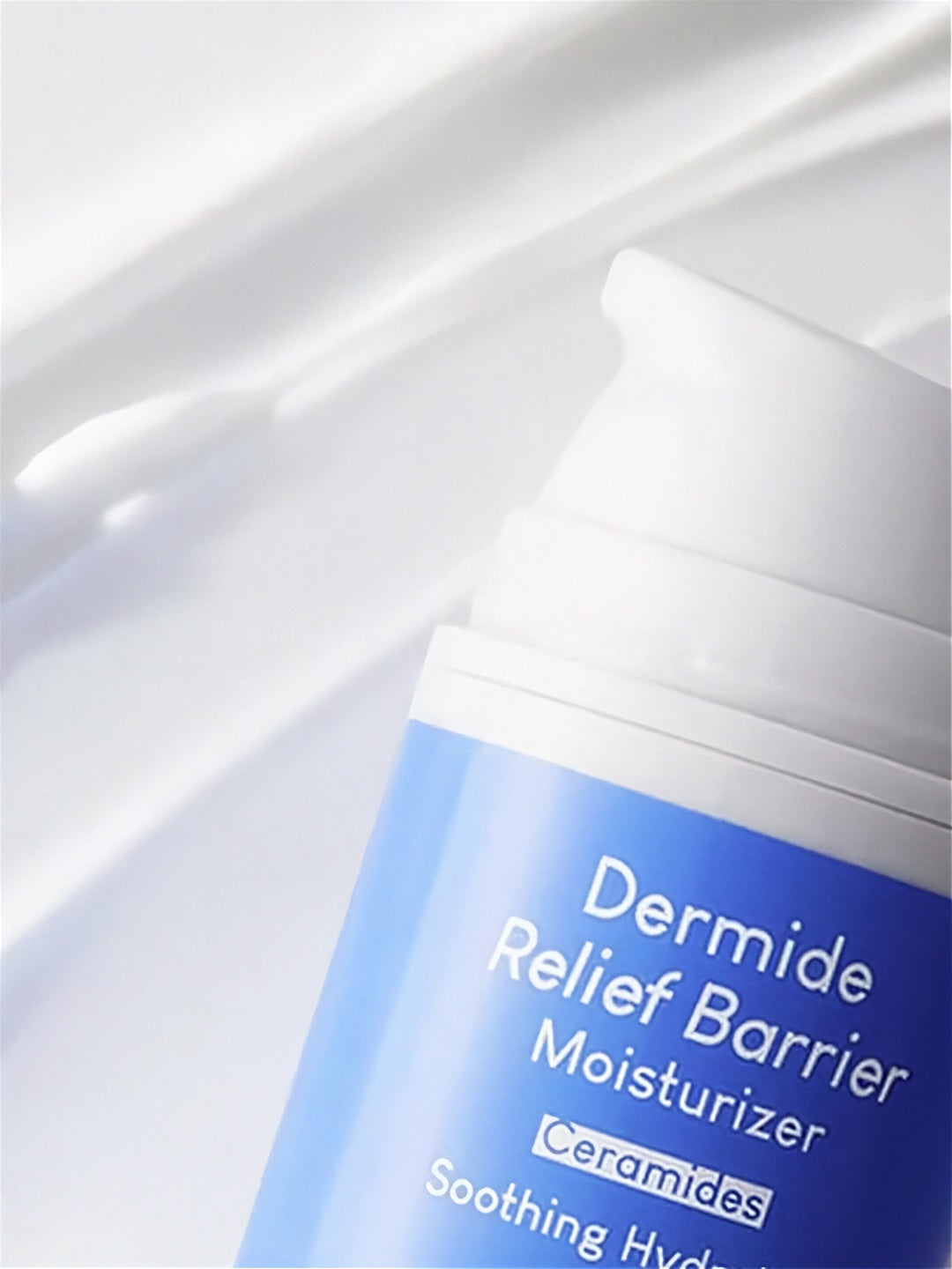 Close up of label from Purito Dermide Relief Barrier Moisturizer on a white creamy texture background
