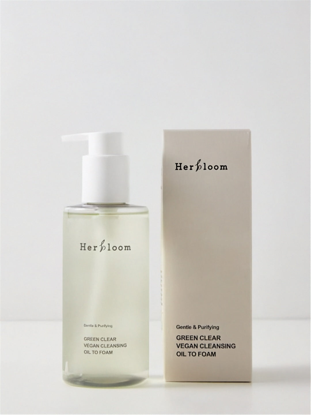 Herbloom Green Clear Cleansing Oil to Foam pump bottle standing next to its retail box against a white background