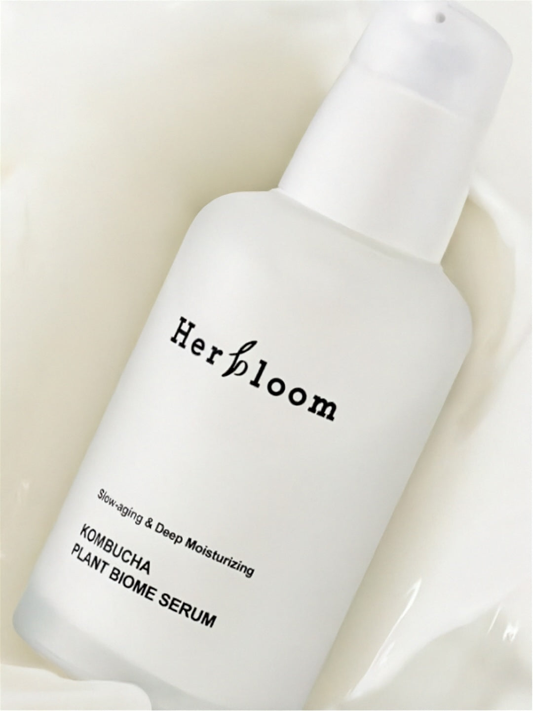 Herbloom Kombucha Plant Biome Serum on a white creamy surface
