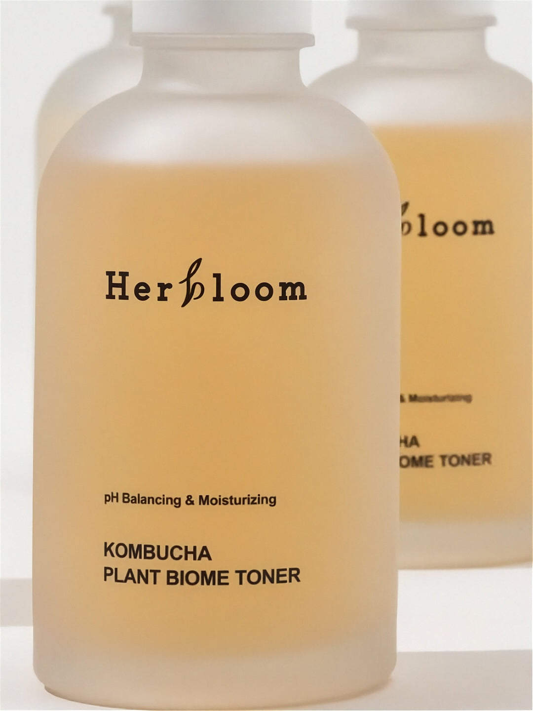 Close up of Herbloom Kombucha Plant Biome Toner bottles on a white baackground