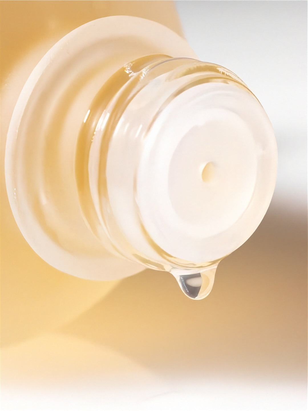 Close up of open cap from bottle of Herbloom Kombucha Plant Biome Toner with a drop of liquid