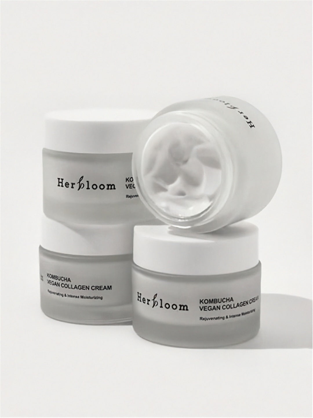Four jars of Herbloom Kombucha Vegan Collagen Cream on a white background