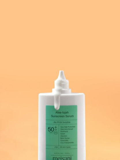 Open tube of Meisani Aloe-lujah Sunscreen Serum on a light orange background