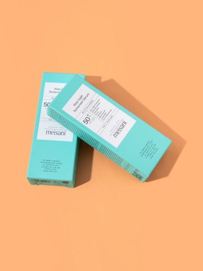 Two retail boxes of Meisani Aloe-lujah Sunscreen Serum on an orange background