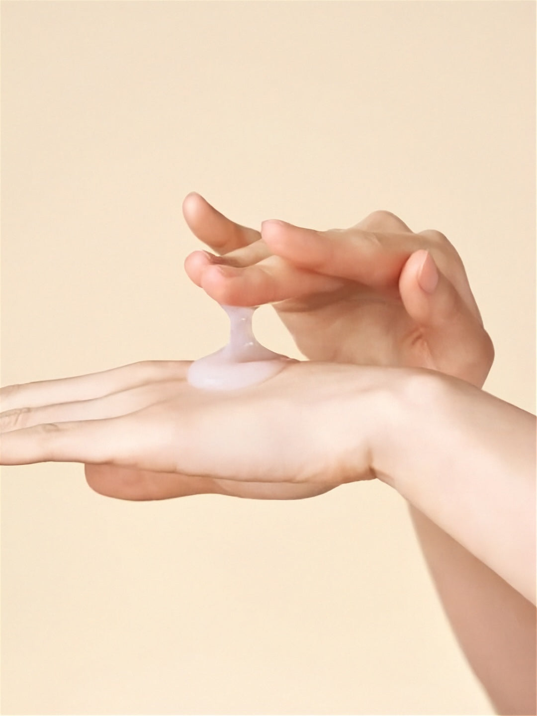 Hand applying Purito Seoul Oat In Calming Gel Cream to another hand against a beige background
