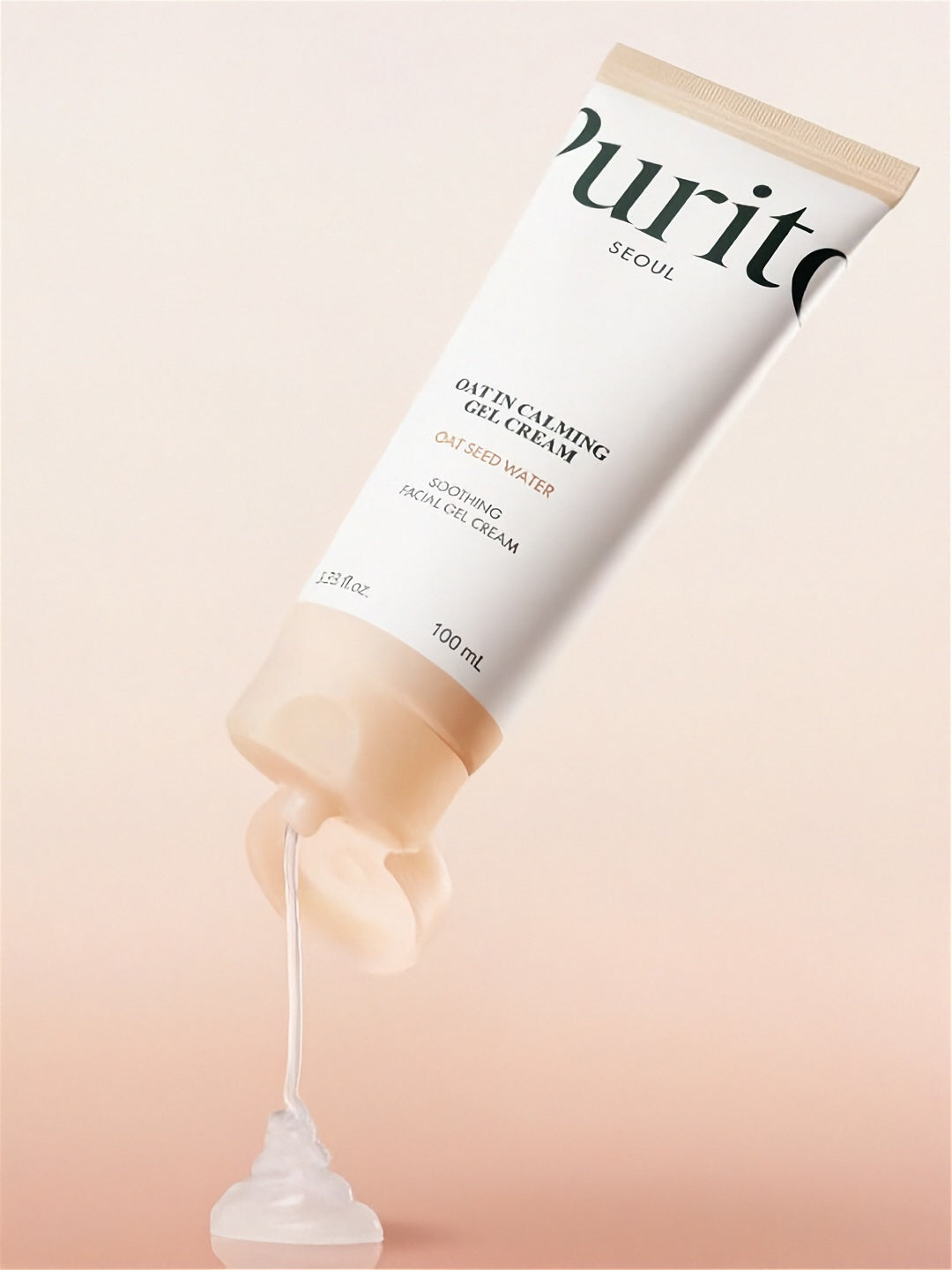 Tube of Purito Seoul Oat In Calming Gel Cream with cream being squeezed out on a beige background
