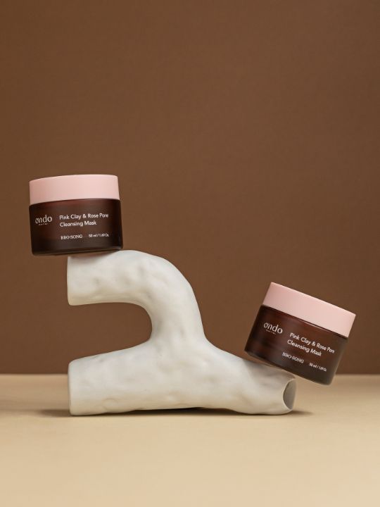 Two jars of Ondo Beauty Pink Clay & Rose Pore Cleansing Mask on a brown background