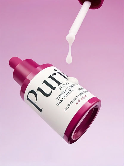 Bottle of Purito Timeless Bloom Backuchiol Serum with liquid coming from a dropper, floating on a light pink background