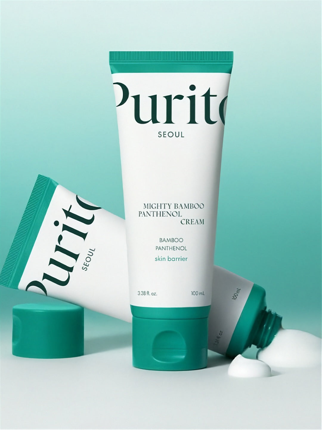 Two tubes of Purito Seoul Mighty Bamboo Panthenol Cream on a light turquoise background, with one bottle open showing cream coming out.