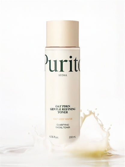 Purito Oat PDRN Gentle Refining Toner bottle with a splash of white liquid on a white background