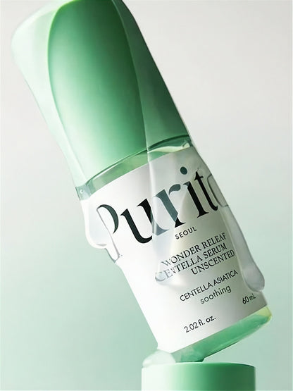 Tube of Purito Wonder Releaf Centella Serum Unscented cover in clear liquid, tilted sideways on a gradient light green background.
