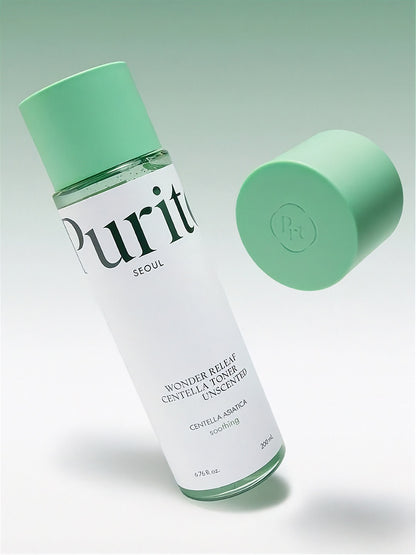 Bottle of Purito Wonder Releaf Centella Toner Unscented tilted sideways with a green cap floating next to it, against a light gradient green background