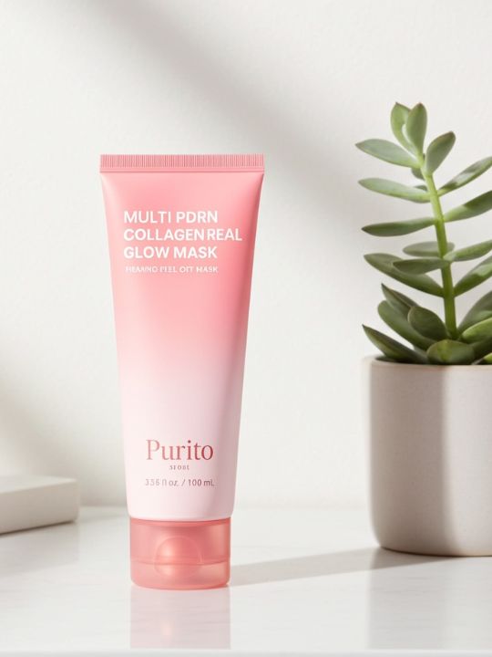 Pink tube of Purito multi pdrn collagen real glow mask on a white surface with a plant in the background