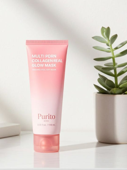 Pink tube of Purito multi pdrn collagen real glow mask on a white surface with a plant in the background