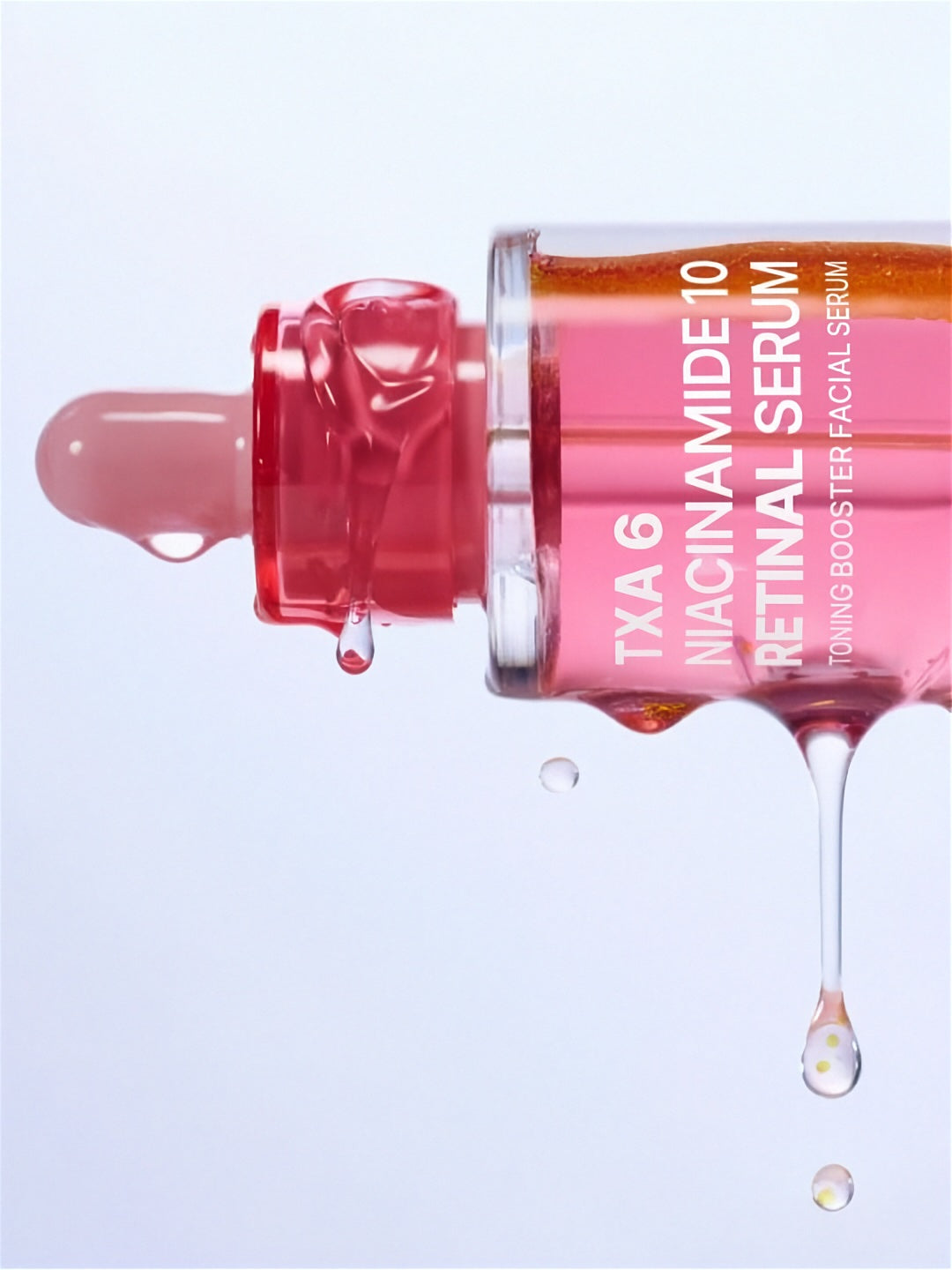 Bottle of Purito Seoul TXA 6 Niacinamide 10 Retinal Serum floating on its side with serum running down, against a white background