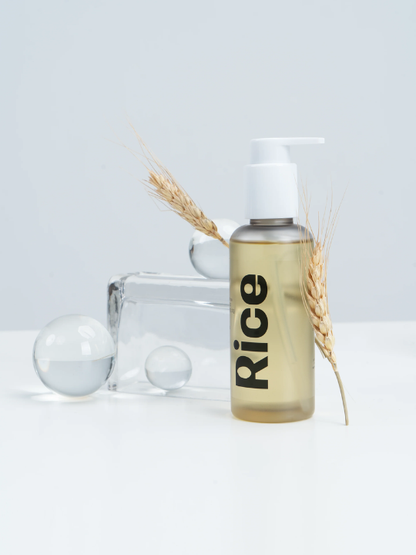 Vegreen Rice Cleansing Oil with wheat stalks on a white background. Available at Sinless Skincare.