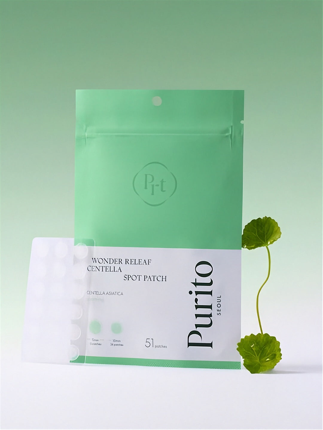 Purito Wonder Releaf Centella Spot Patch packaging with cica plant on a gradient green background