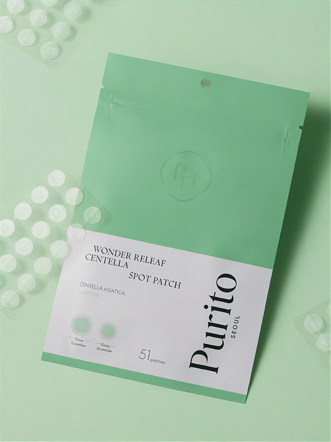 Purito Wonder Releaf Centella Spot Patch inner and outer packaging lying on a light green surface