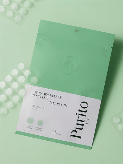 Purito Wonder Releaf Centella Spot Patch inner and outer packaging lying on a light green surface