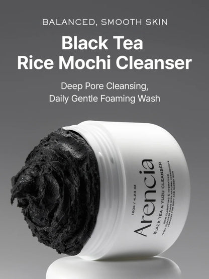 A white jar of Arencia Black Tea Rice Mochi Cleanser with a swirl of thick black cleanser visible on the left side, set against a dark gray gradient background with product text above.