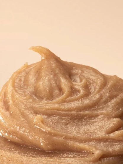Close-up of a swirl of Arencia Calendula Rice Mochi Cleanser on a beige background
