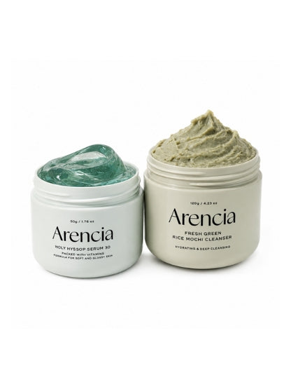 Open jar of Arencia's Holy Hyssop Serum 30 and Fresh Green Rice Mochi Cleanser on a white background