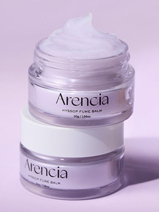 Two jars of Arencia Hyssop Fume Balm on pink background