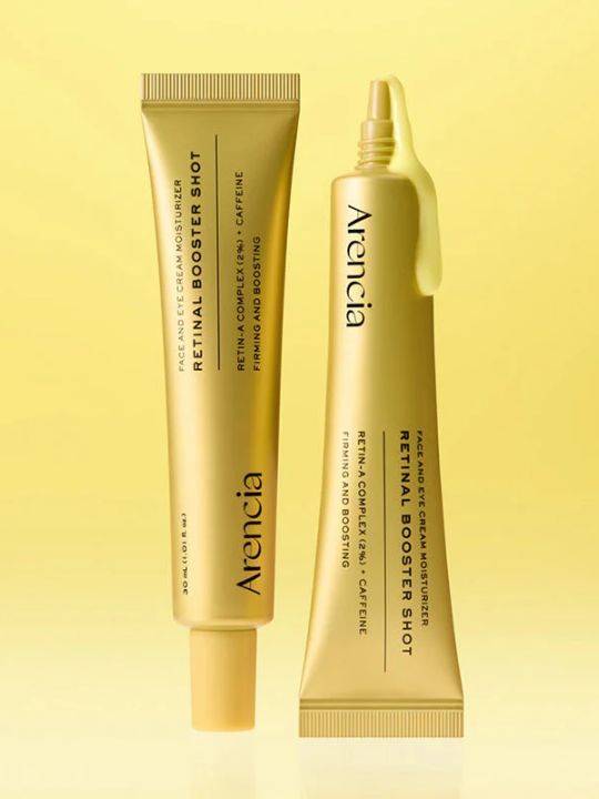 Two tubes of Arencia Retinal Booster Shot with cream coming from one on a yellow background