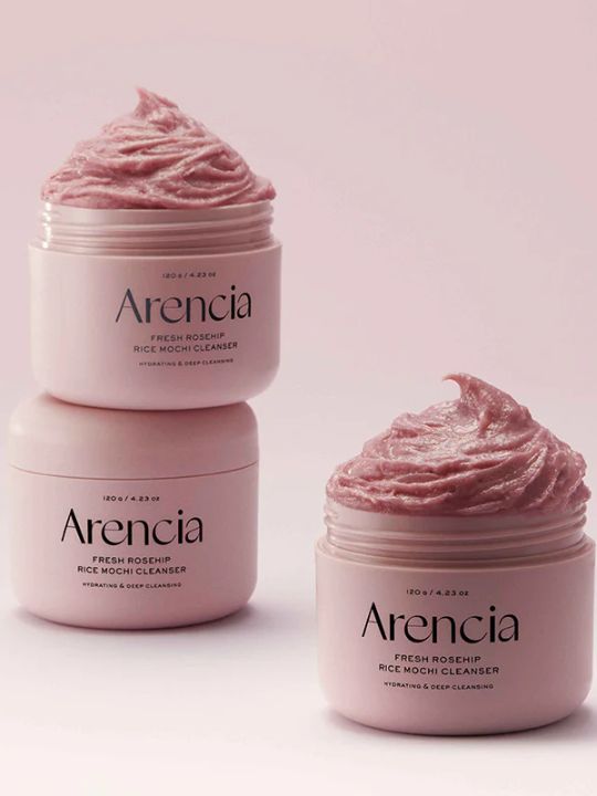 Three jars of Arencia Fresh Rosehip Rice Mochi Cleanser on a light pink background