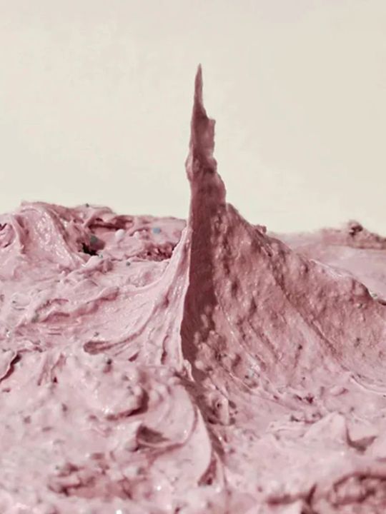 Close-up pink texture of Arencia Rosehip Rice Mochi Cleanser on a beige background