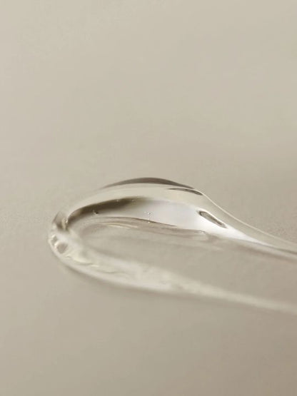 Close up texture swatch of Aromatica Organic Aloe Vera Gel on a light grey surface