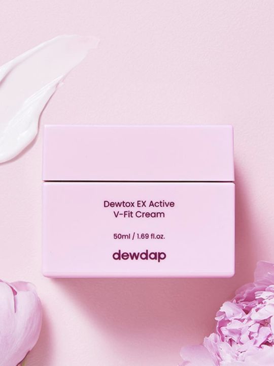 Pink jar of Dewdap's Dewtox EX Active V-Fit Cream with floral elements on light pink background