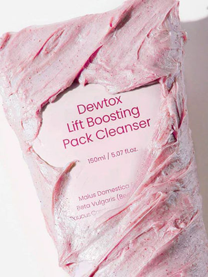 Close up of Dewdap's Dewtox Lift Boosting Pack Cleanser tube covered in pink cream, against a light pink background