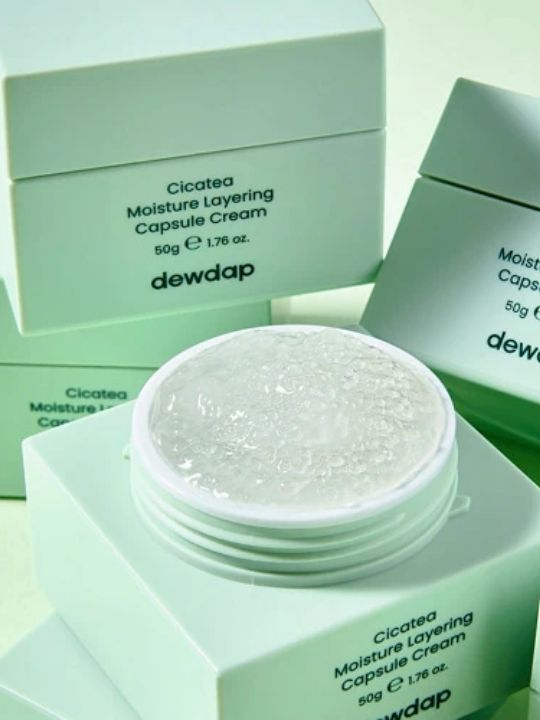 Dewdap Moisture Layering Capsule Cream surrounded by other jars on a light green background